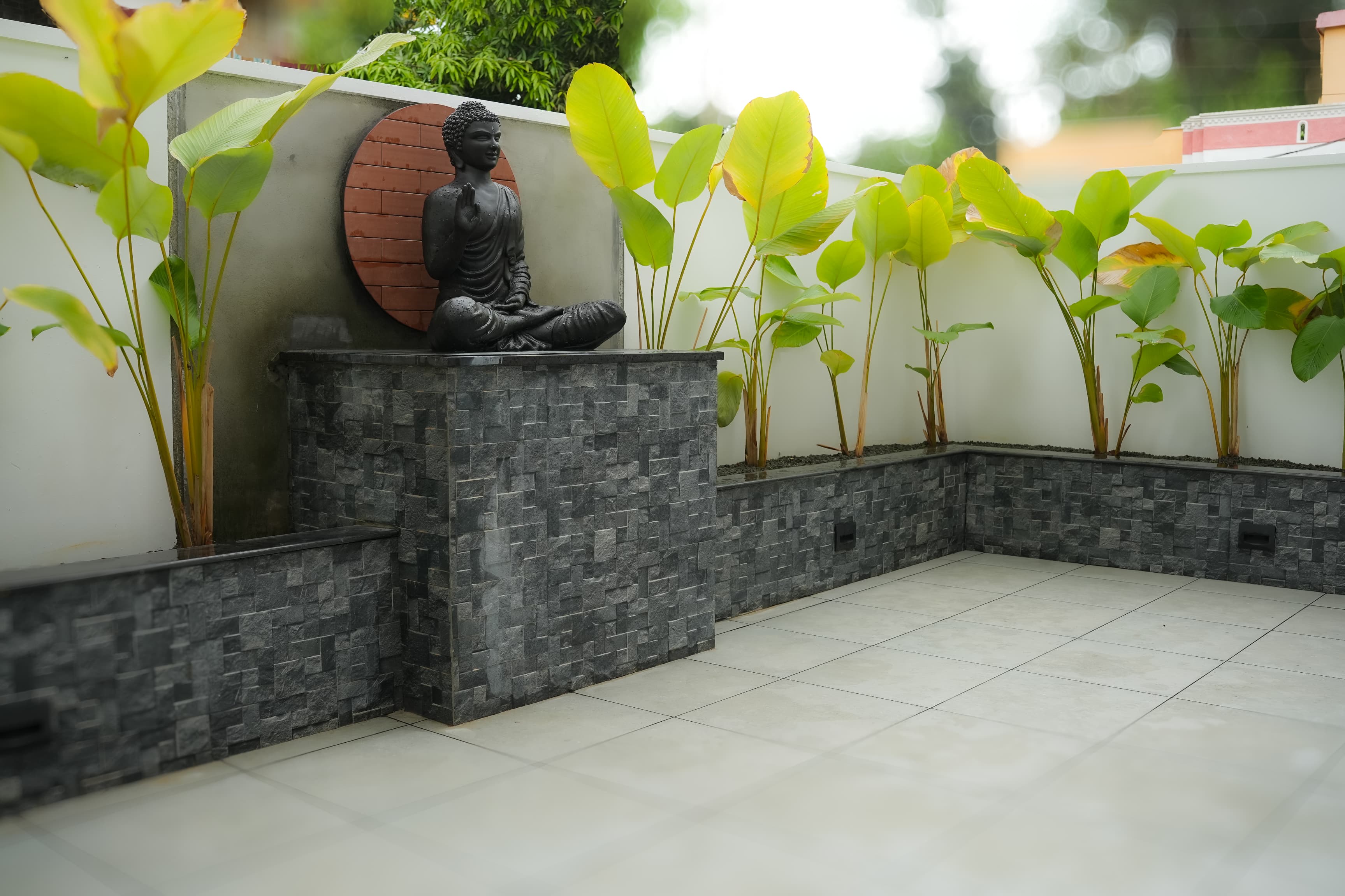 Open external courtyard with natural lighting and seating area at Pallichal, Thiruvananthapuram