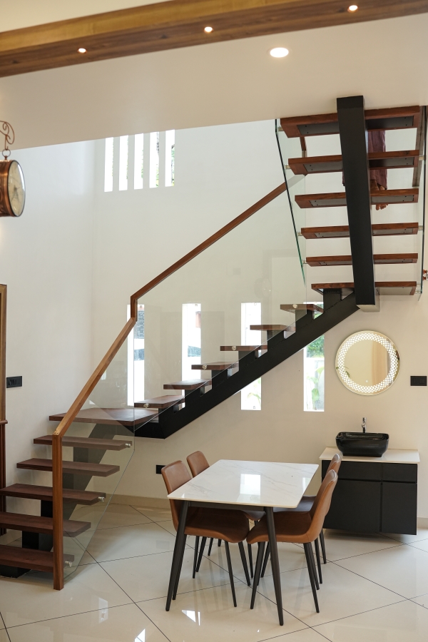 Elegant wooden staircase with glass railing at Pallichal, Thiruvananthapuram