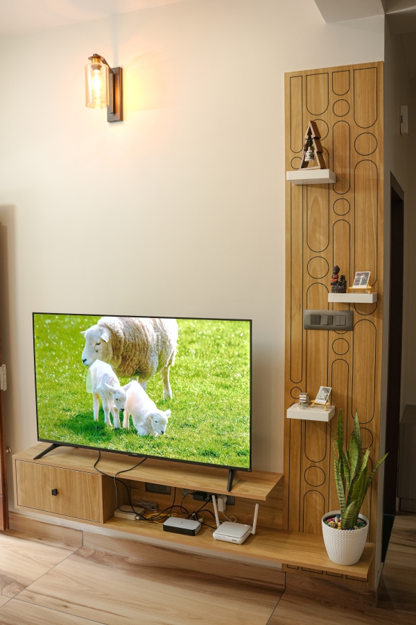 Custom-designed wooden TV unit with wall-mounted panel at Peyad, Thiruvananthapuram